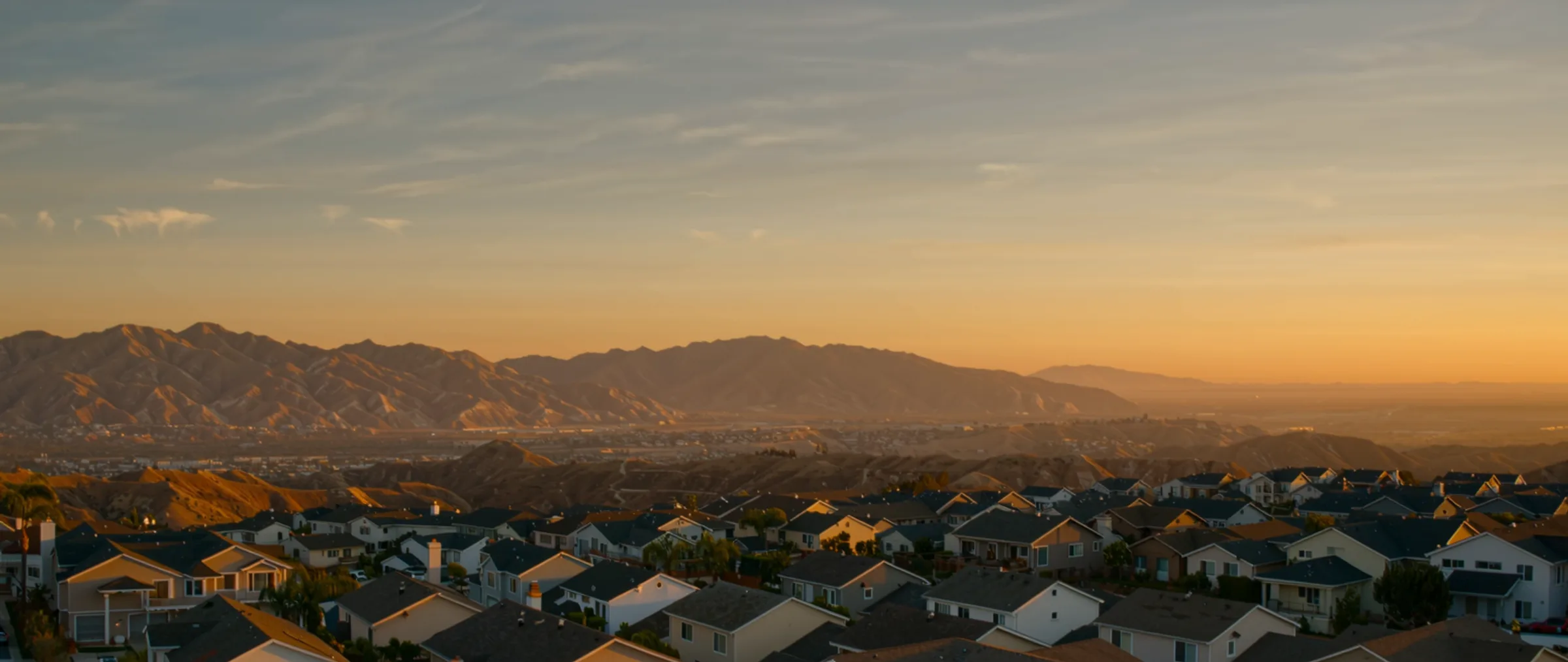 Wide cinematic view of the El Cajon valley with East County foothills