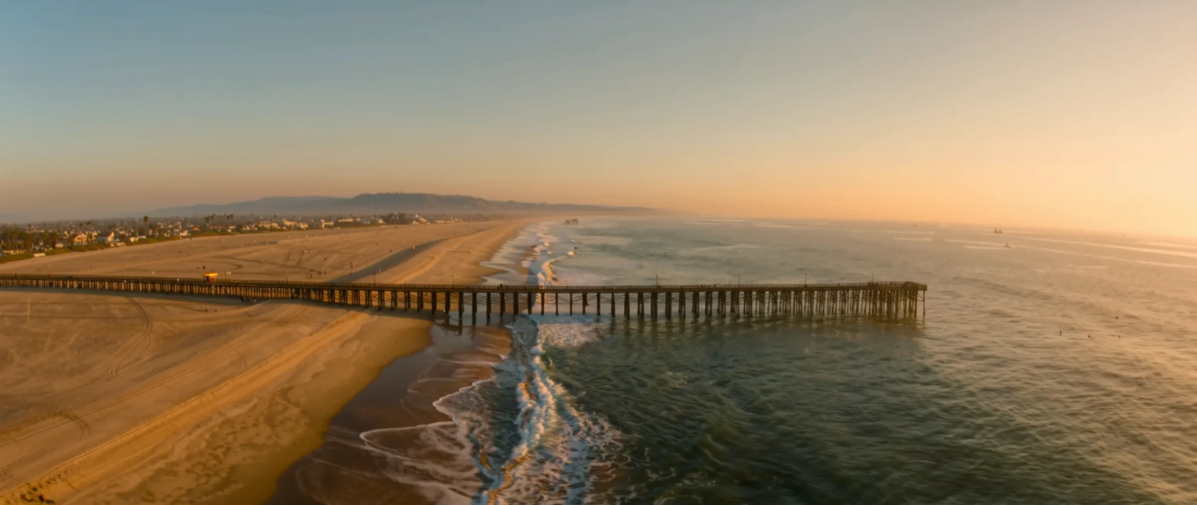 Wide cinematic view of the Imperial Beach pier and coastline
